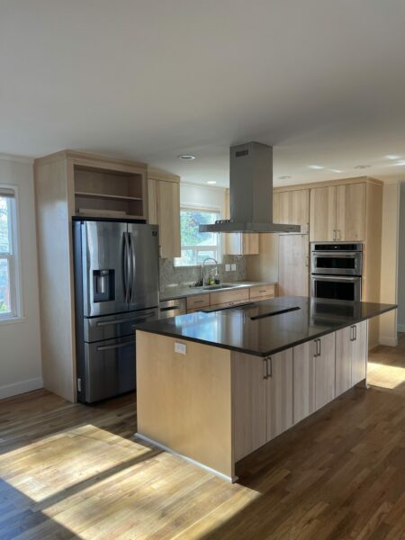 Oak floors, quartz countertops, wood cabinets, natural light, quartz backsplash, open kitchen